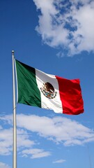 Mexican flag waving in a clear sky