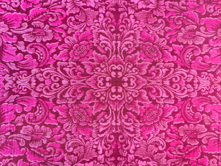 Traditional pink magenta fabric in classic ornamental floral pattern. Paisley pattern on ethnic cloth fabric, suitable for fashion, upholstery, and table runner. Seamless texture