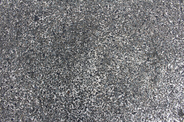 Close up of gravel aggregate concrete road texture background. Rough surface of pebbles embedded grey asphalt texture.	