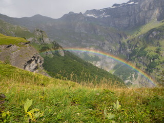 Vogealle, France - September 24th 2024: Beautiful rainbow in a wild mountain landscape.