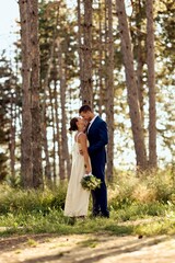 Romantic Wedding Couple Embracing in a Scenic Forest Setting