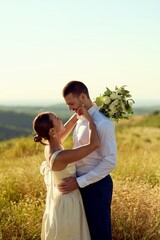 Romantic Outdoor Wedding Couple Embracing in Scenic Field Setting