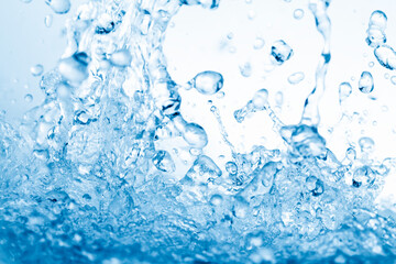 青の背景に飛び散る水飛沫.