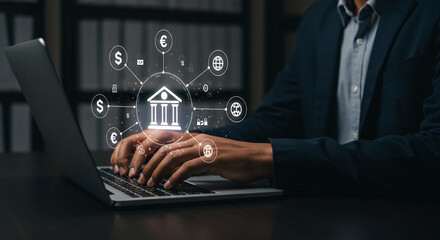 A man in a suit types on a laptop with a bank icon and currency symbols displayed above, representing online banking.
