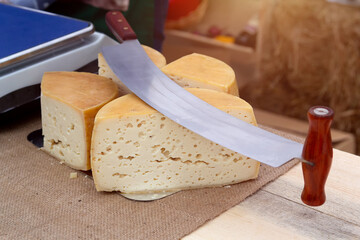 Craft cheese and knife for cheese for sale at a farmer's market
