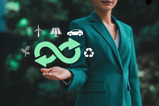 Woman s hand showcasing the circular economy symbol surrounded by icons representing renewable energy and sustainability concepts