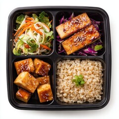 A black plastic container filled with rice, tofu, tofu, and tofu