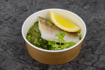 white fish steaks in disposable dishes macro photo