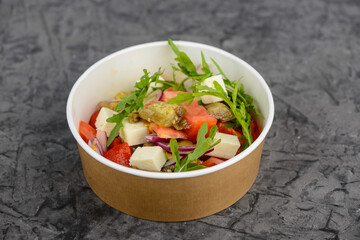 fresh tomato salad in a disposable container
