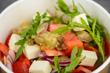 fresh tomato salad in disposable dishes macro photo