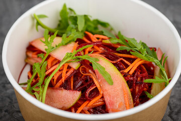 beetroot, carrot and pear salad in disposable dishes photo