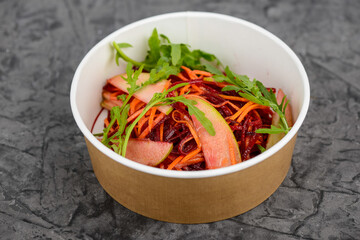 beetroot, carrot and pear salad in a disposable dish macro photo