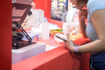 Woman is ordering food at the counter of a food shop