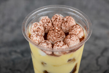 tiramisu dessert in disposable dishes macro photo