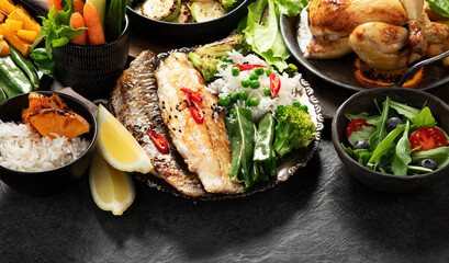 Table scene of various delicious foods. Healthy, family dinner.