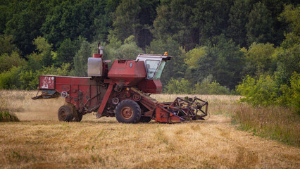 A Soviet combine harvester is working in the field