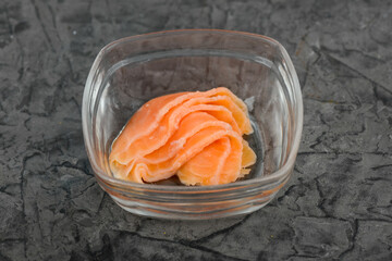 pieces of salmon in a transparent shallow plate