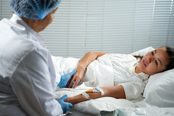 Nurse Attending to a Patient in a Hospital Bed