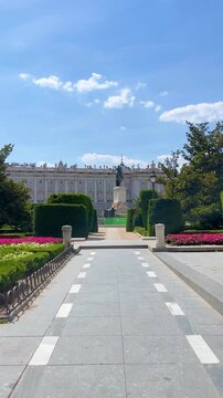 POV Point of view of male pedestrian crossing leading toward historic Madrid's downtown, capturing summer cityscape from first-person walking perspective with sunny urban landscape