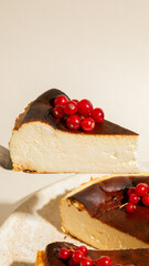 Golden-brown Basque cheesecake crowned with glistening red currants, perfect for indulgent...