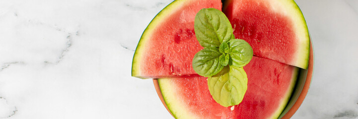 Juicy watermelon with basil crown, summertime refreshment with vibrant zest, heralds Watermelon Day and Picnic Under the Stars vibes