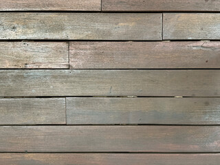 Fototapeta premium Close up of natural grey wood decking with grouts, suitable for outdoor pool deck. Wooden deck seamless background texture, natural wood, PVC wood texture. No people.