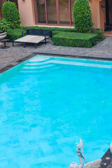 Empty swimming pool with sunbed and white umbrella in resort hotel for vacation leisure and white sand,resort neary sea and beach in summer.