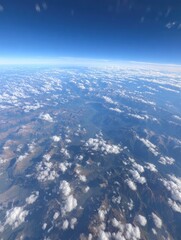 High-altitude view of Earth's surface, clouds, and mountains