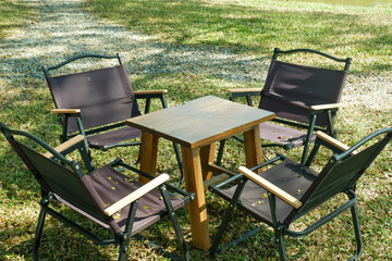 Camping table and Camp chair set in garden on a sunny day near river,outdoor seating for restaurant...