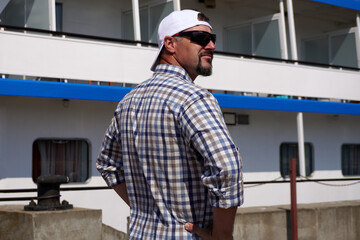 Ship tourist watching river passenger vessel docked at pier