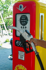 Bangkok, THAILAND - May 1, 2025:Close up fuel nozzles at gas station,Petrol pump filling fuel...