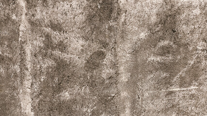 Rough concrete wall surface with natural marks and stains in a close-up shot, ideal for industrial...