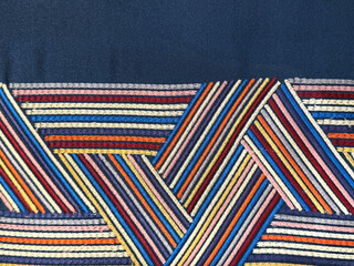 Close up of colorful blue rainbow fabric in diagonal interweaving pattern. Suitable for graphic background and fabric upholstery. Seamless background texture