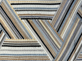 Close up of colorful grey rainbow fabric in diagonal interweaving pattern. Suitable for graphic background and fabric upholstery. Seamless background texture