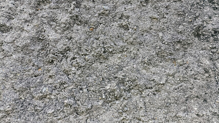 Close-up shot of weathered concrete surface with textured patterns and light damage. Grunge background ideal for construction, decay visuals, or architectural reference materials.