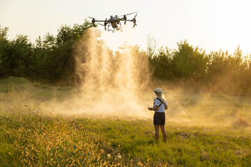 A drone disperses particles over a golden field during the golden hour, reflecting technological...