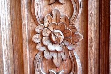 Image of teak wood door carved into flower shape