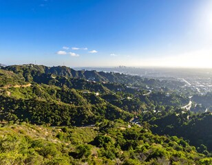 Obraz premium Panoramic view of a valley with hills and city