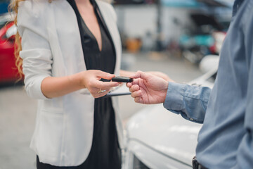 Car dealer handing keys to male customer, symbolizing successful purchase, new ownership, and trusted service in automotive sales, finance, and insurance.