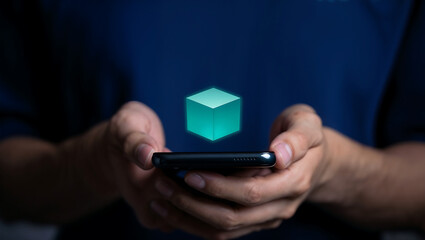 Hands holding a smartphone displaying a glowing green cube hologram