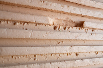Panels of orange insulation. Stack of construction foam insulation.