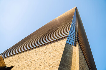 Shanghai. A striking view of a stone, metal, and glass building in vibrant downtown Shanghai under...