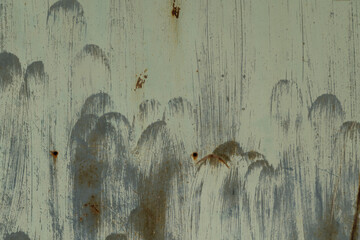 Aged painted metal surface with faded blue-green tones, visible rust and vertical brush marks,...