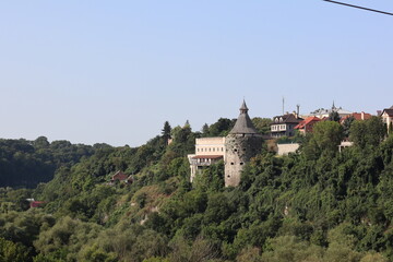 Historic fortress overlooking lush green valley in tranquil countryside setting during bright sunny...
