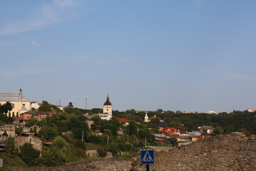 Scenic view of a historic town with colorful houses and a church on a sunny day