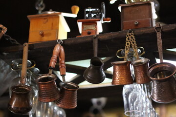 Traditional coffee accessories hanging in a rustic cafe with vintage charm located in a historic...