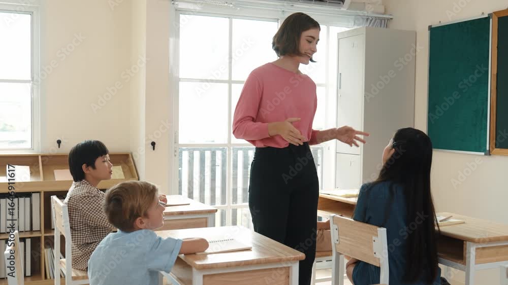 Aufkleber caucasian teacher walking and check student homework at classroom while diverse children doing class
