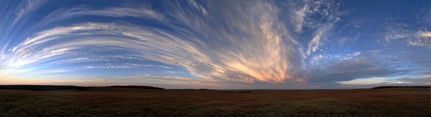 Obraz premium Dramatic cloudscape over a flat landscape at sunset