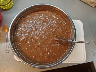 Cocoa gingerbread dough in metal bowl ready to be poured on tray