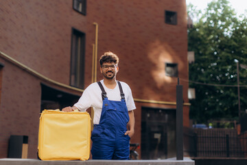 Courier delivering food with thermal backpack in city street